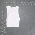 White tank top on a gray background with measurement scale