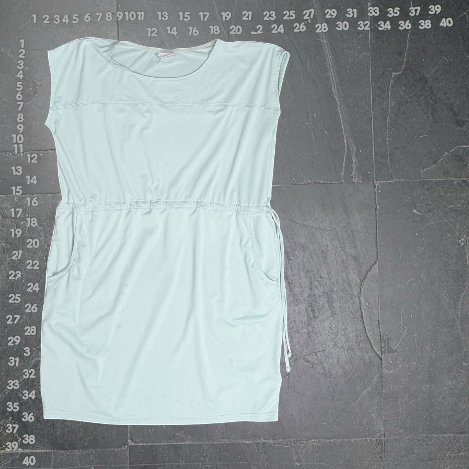 Columbia spray green sleeveless drawstring waist dress with pockets. Lightweight, breathable fabric, ideal for casual wear or travel.