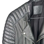 The Room Collective black leather biker jacket with quilted shoulders and asymmetric zip front.