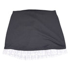 The Room Collective black mini skirt with white ruffled hem. High-waisted, slim fit, stretchy polyester/spandex blend with cotton ruffle.