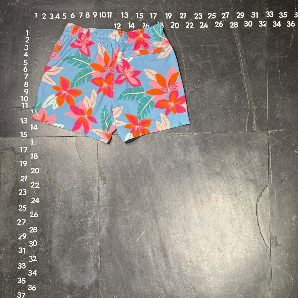 The Room Collective light blue floral print swim trunks for men, size small, with pink and orange hibiscus flowers.