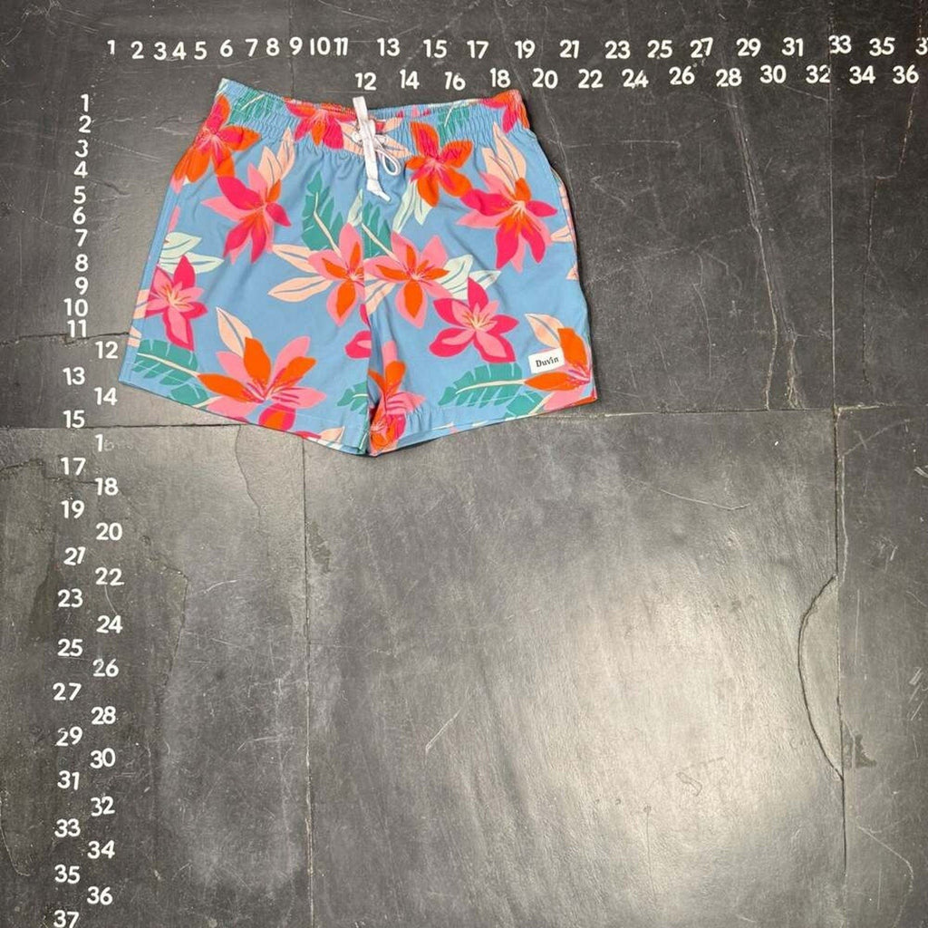The Room Collective light blue swim trunks with pink and orange floral print, size small, elastic waistband, drawstring, and pockets.