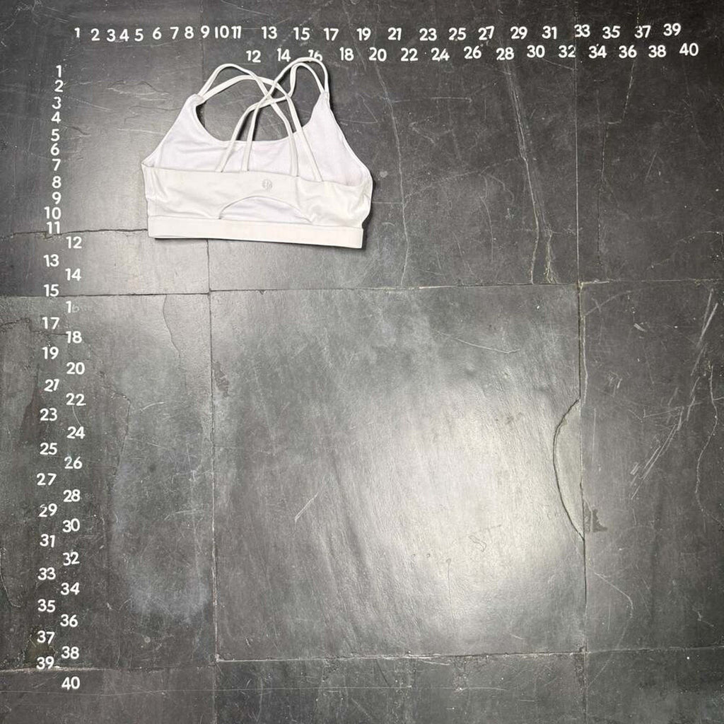 The Room Collective white Lululemon Free to Be Serene bra with strappy back detail, size M. Made from nylon and spandex blend.