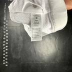 The Room Collective white Lululemon Free to Be Serene Bra, size M, with strappy back detail and mesh lining.