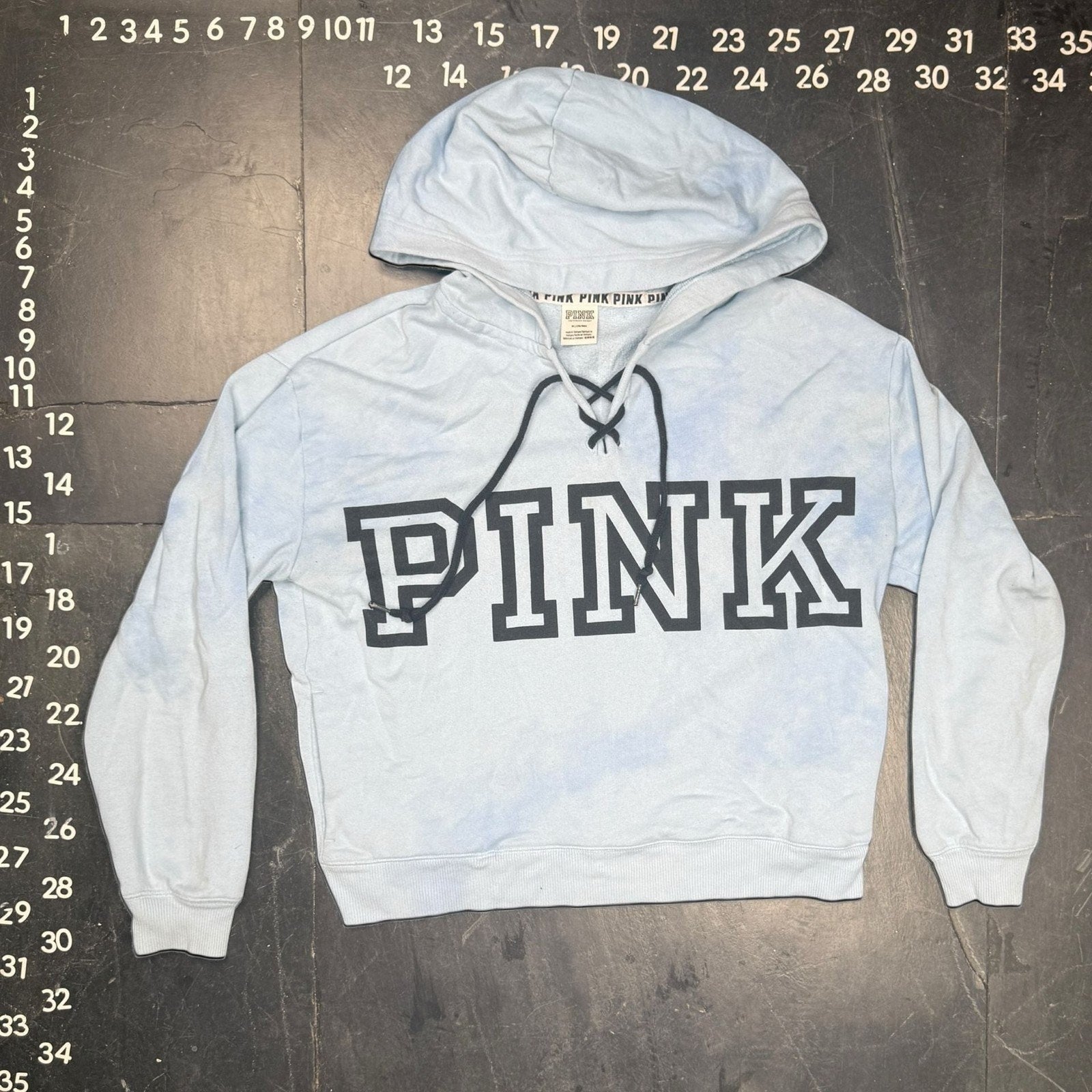 The Room Collective light blue and white tie-dye hoodie with lace-up detail and black PINK logo, size M.