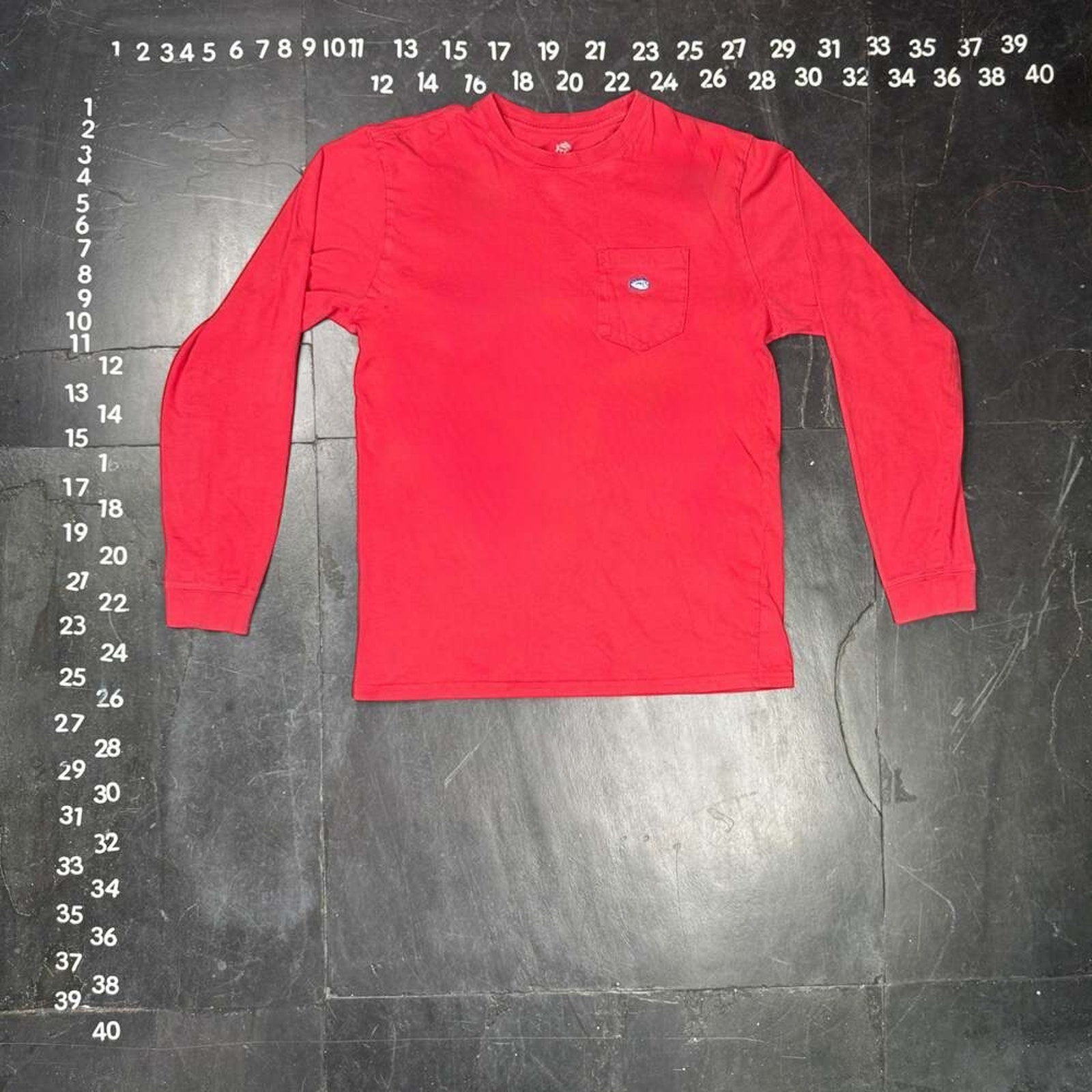 The Room Collective Men's red 100% cotton long sleeve pocket t-shirt, size Small, with skipjack logo detail.