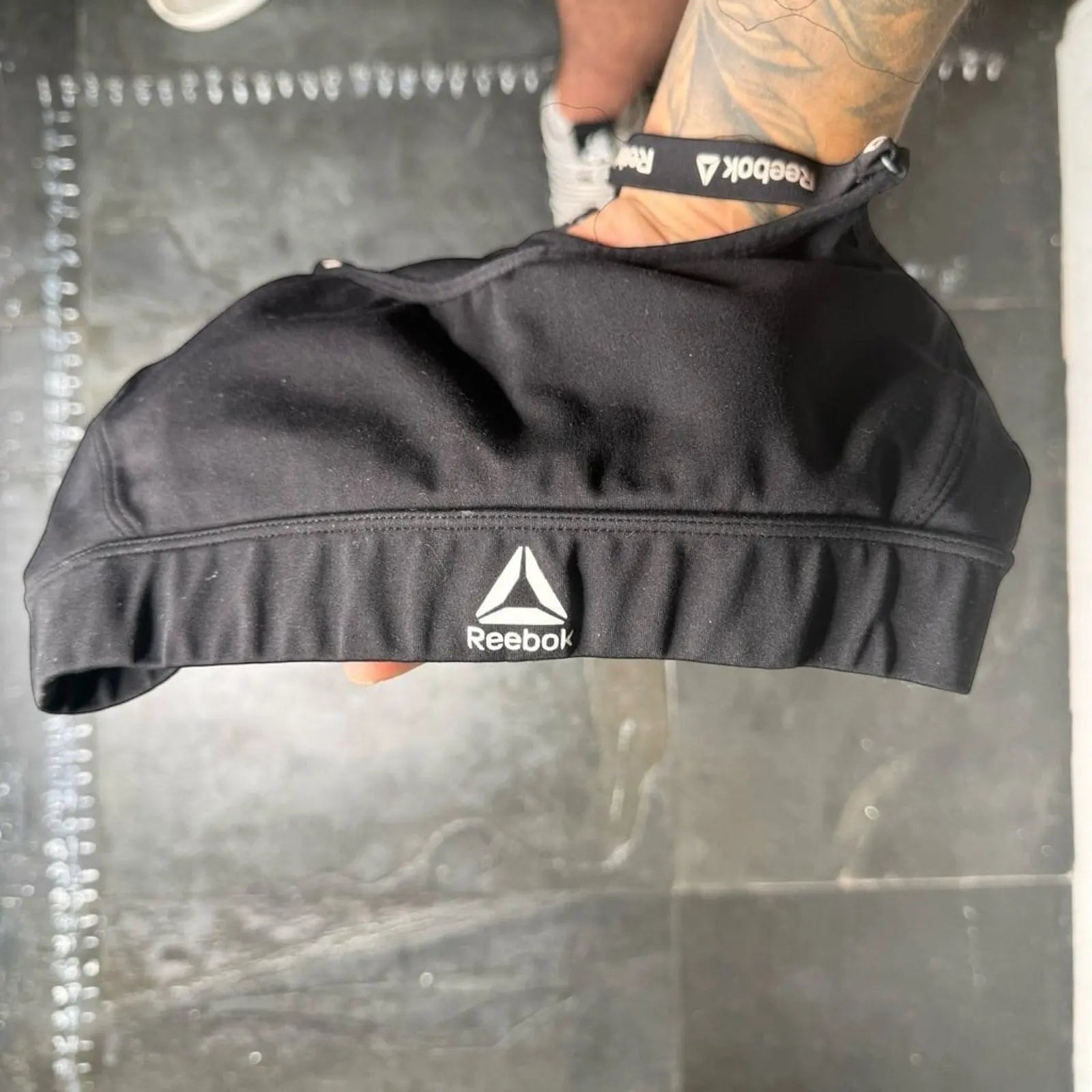 The Room Collective Reebok black logo strap sports bra, size S. Racerback design with performance blend fabric.