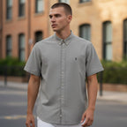The Room Collective AllSaints grey short sleeve button-down shirt with Ramskull logo embroidery on chest, size L.