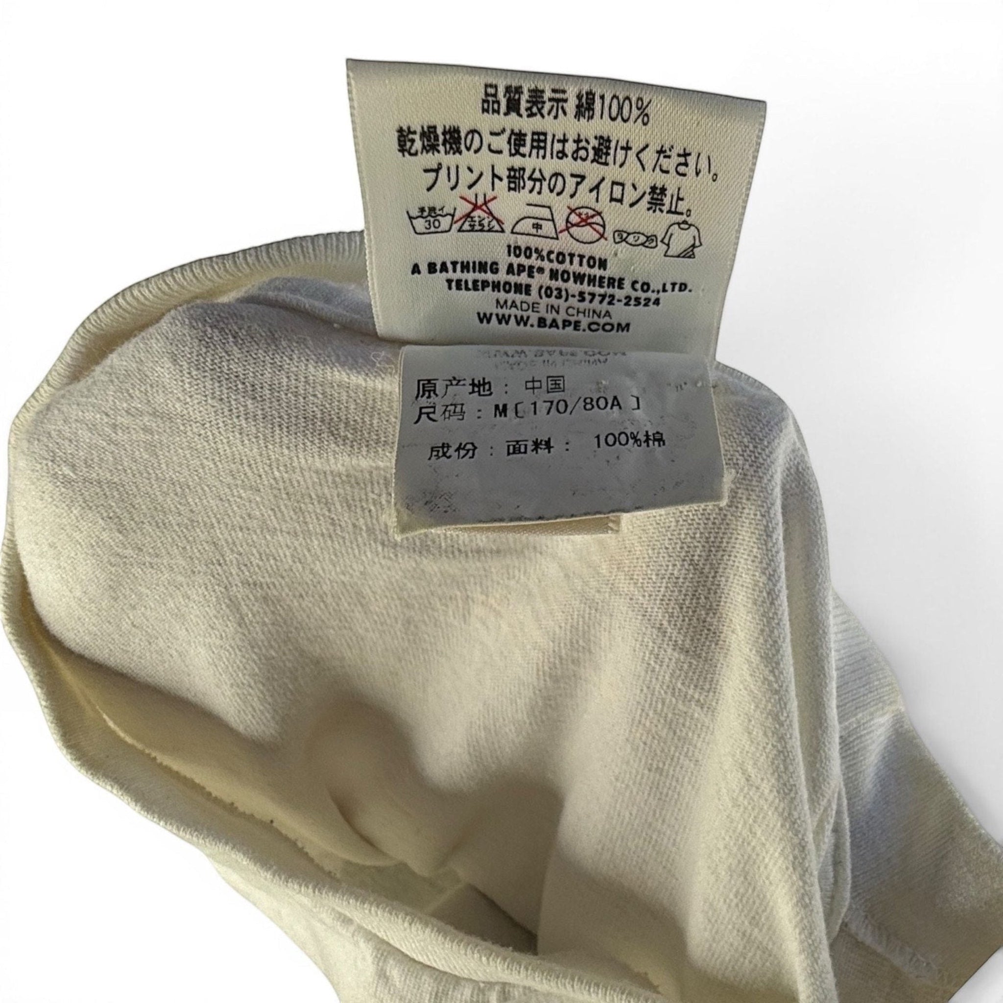 The Room Collective A Bathing Ape white cotton t-shirt with tiger camo Big Ape Head graphic and authentic tags.