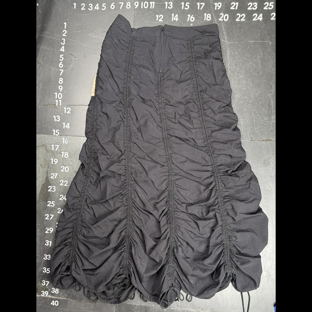 The Room Collective Riley black ruched nylon parachute skirt with adjustable drawstring hem and back zipper closure. Size S.