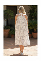 The Room Collective white mini dress with black abstract swirl print, halter neck with tie-back, crinkled fabric.